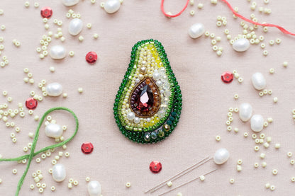 a beaded brooch sitting on top of a table