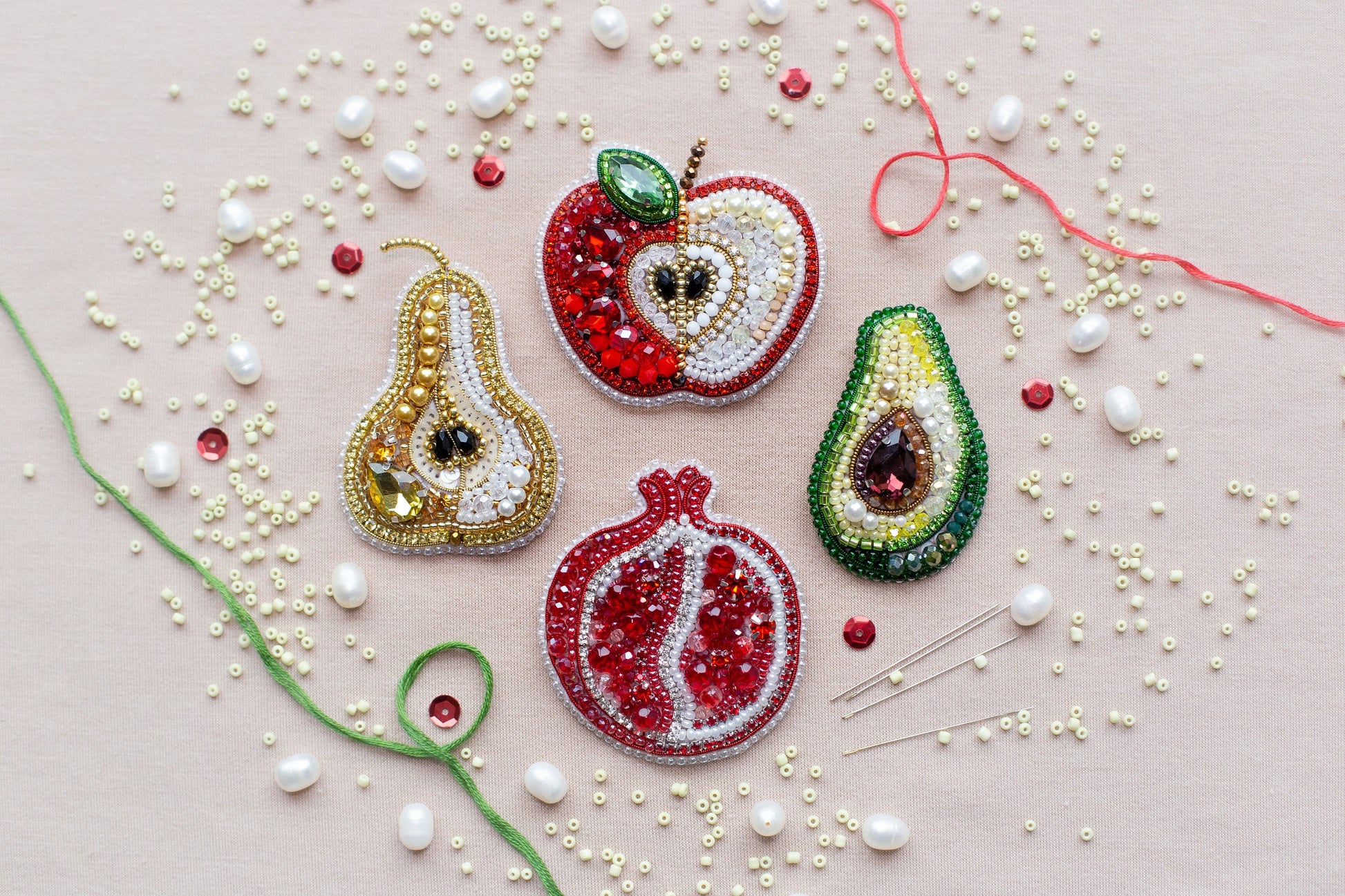 a group of fruit shaped brooches sitting on top of a table