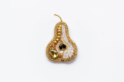 a beaded pear ornament on a white background