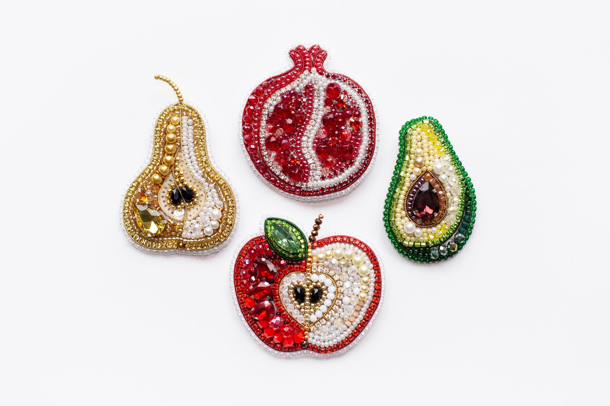 a group of fruit shaped ornaments on a white surface