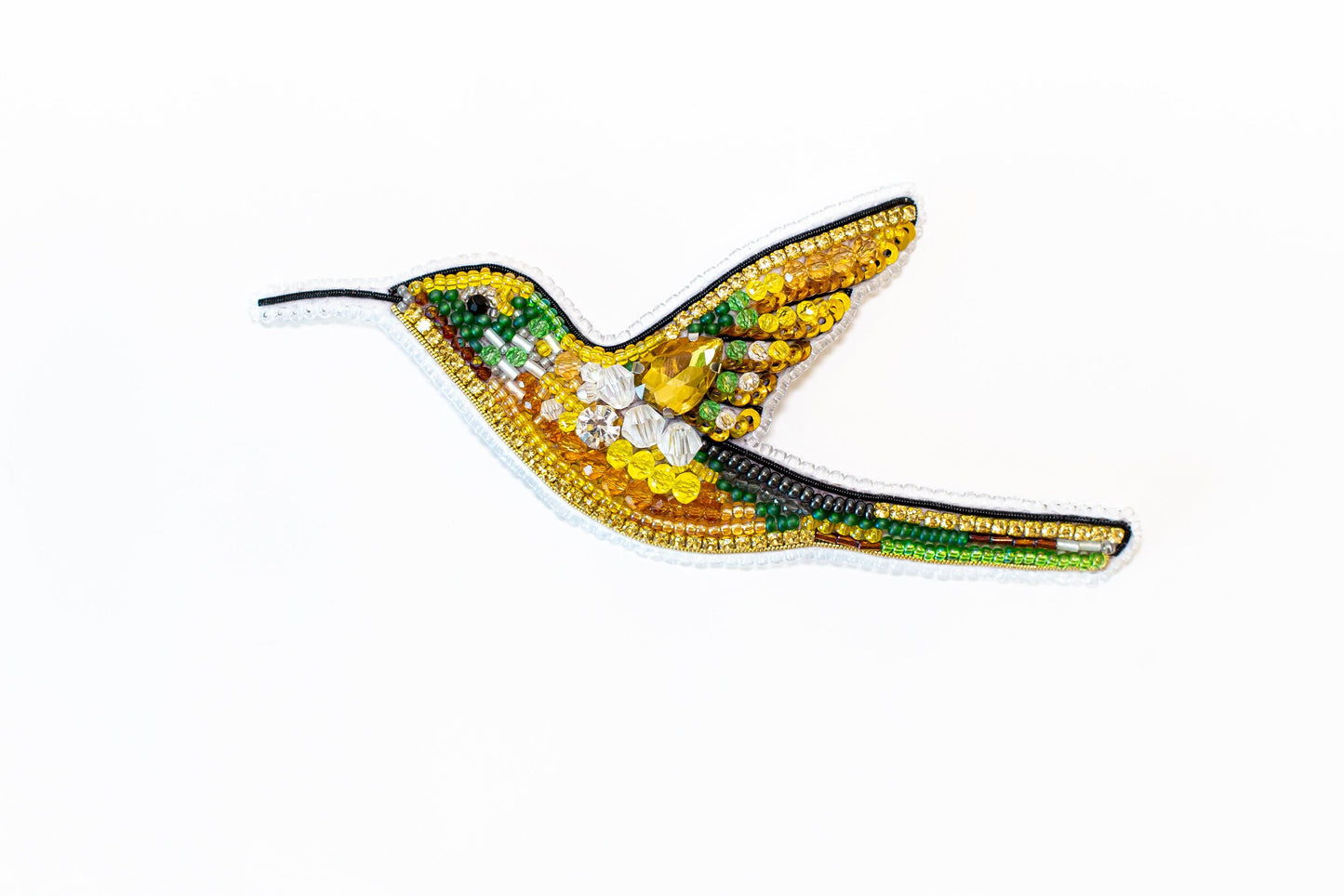 a bird made out of beads on a white background