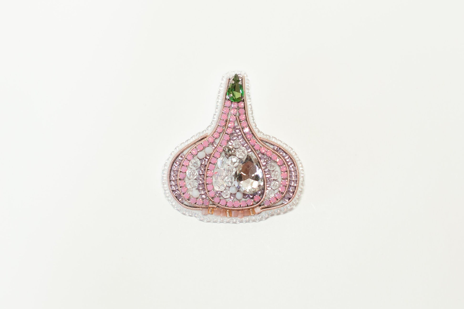 a brooch with a pink and green design