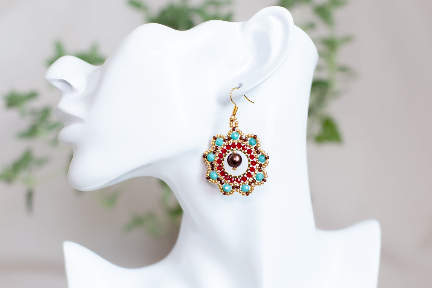 a close up of a pair of earrings on a mannequin head