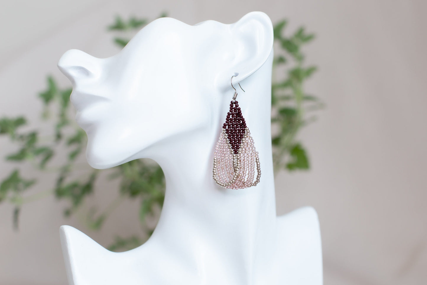 a close up of a pair of earrings on a mannequin head