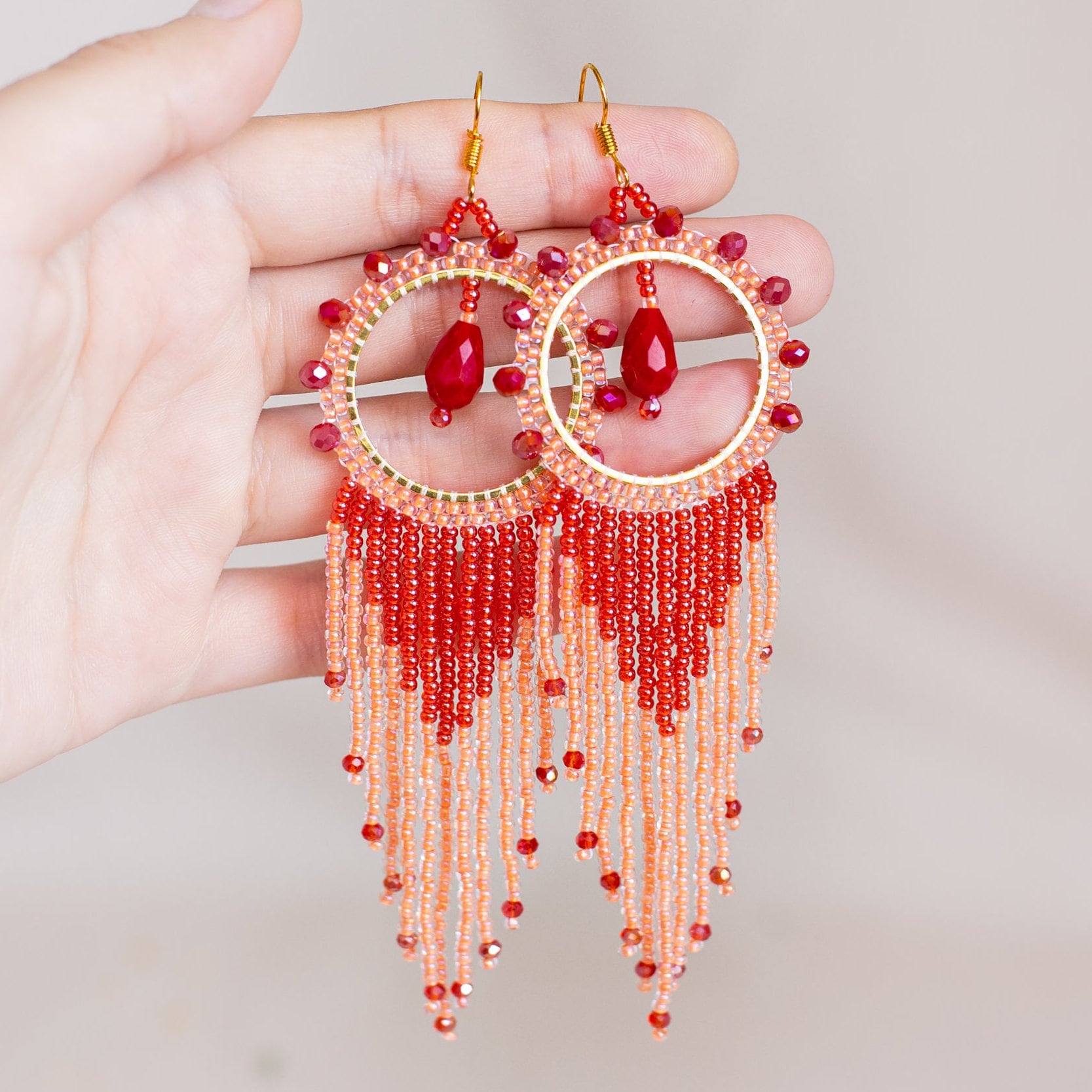 a pair of red and white beaded earrings