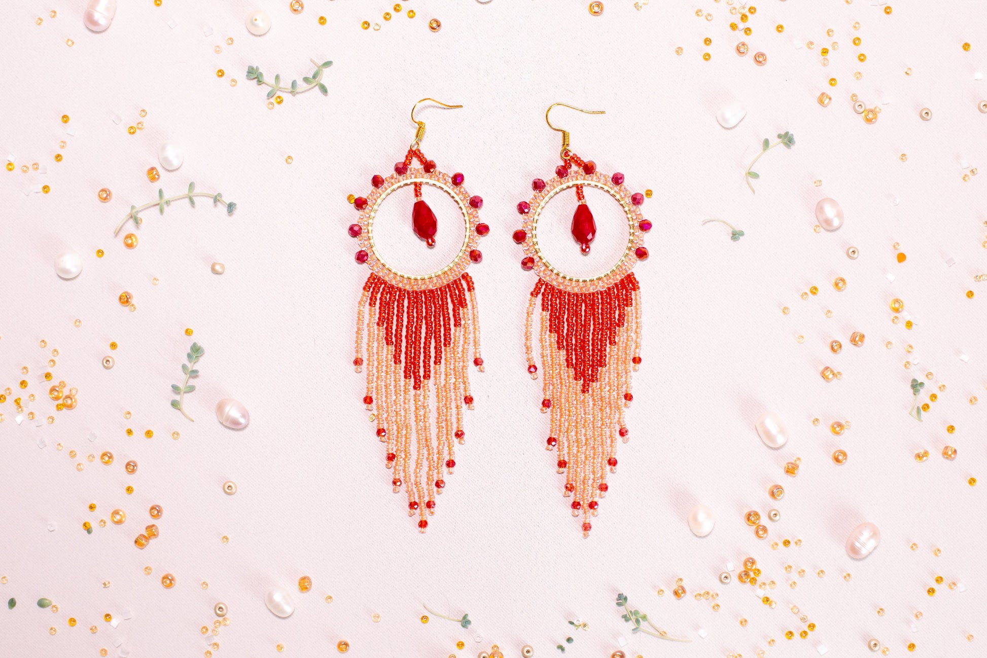 a pair of red and white beaded earrings