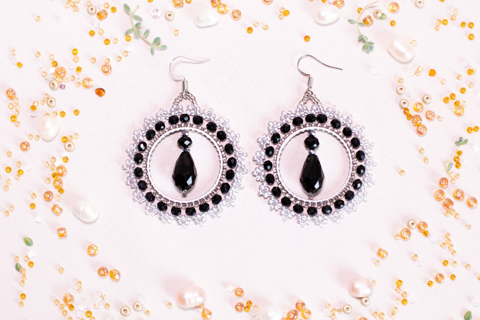 a pair of black and white beaded earrings