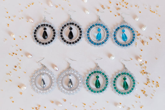 a set of six pairs of earrings on a table