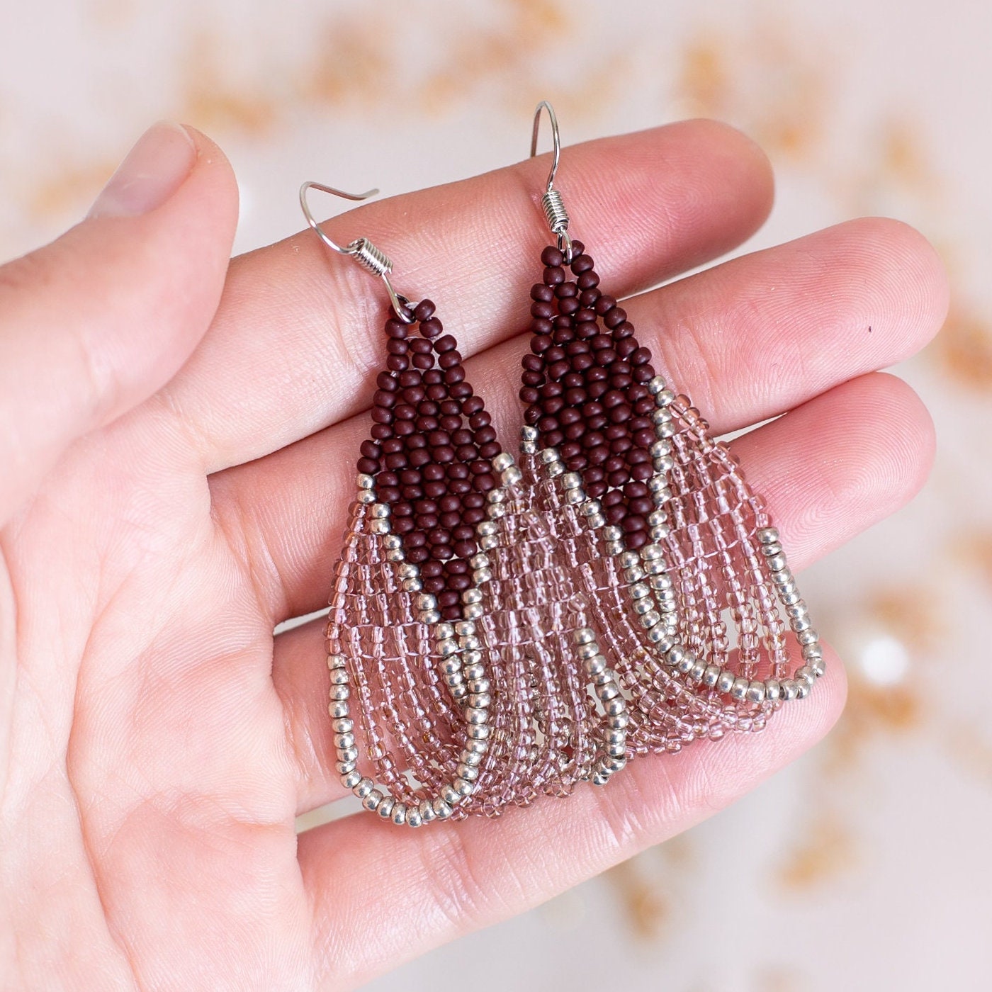 a pair of beaded earrings sitting on top of a table