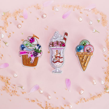 three ice cream pin badges on a pink background