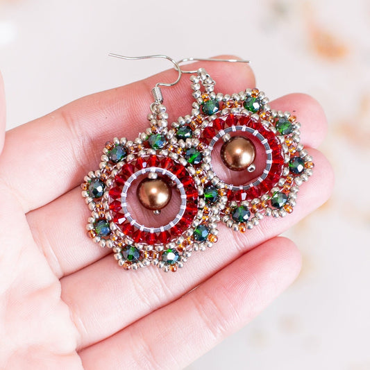 a pair of red and green beaded earrings