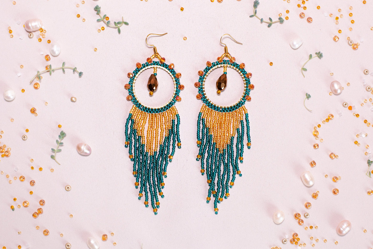 a pair of earrings with beads and beads