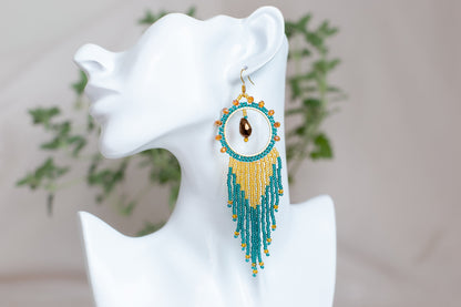 a close up of a pair of earrings on a mannequin head