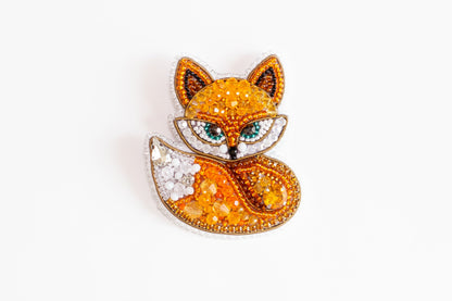 a brooch with a fox on it