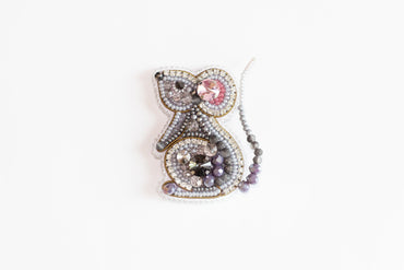 a beaded brooch with a bird on it