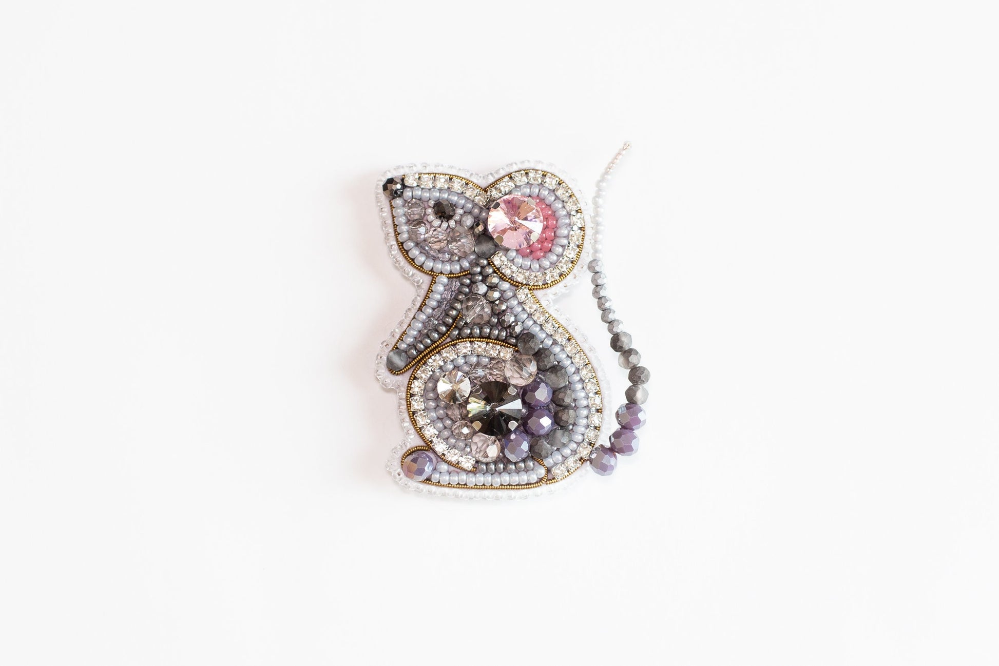 a beaded brooch with a bird on it