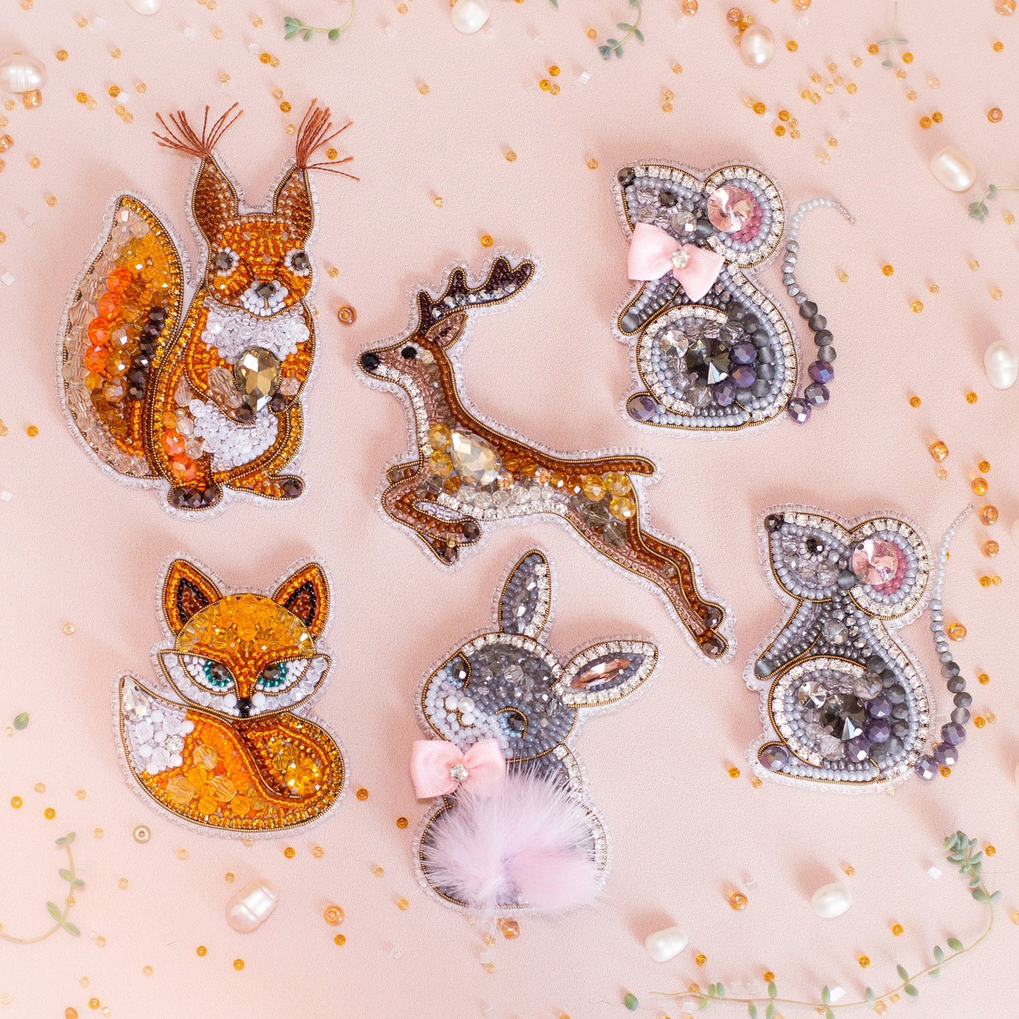 a group of animal brooches sitting on top of a white surface