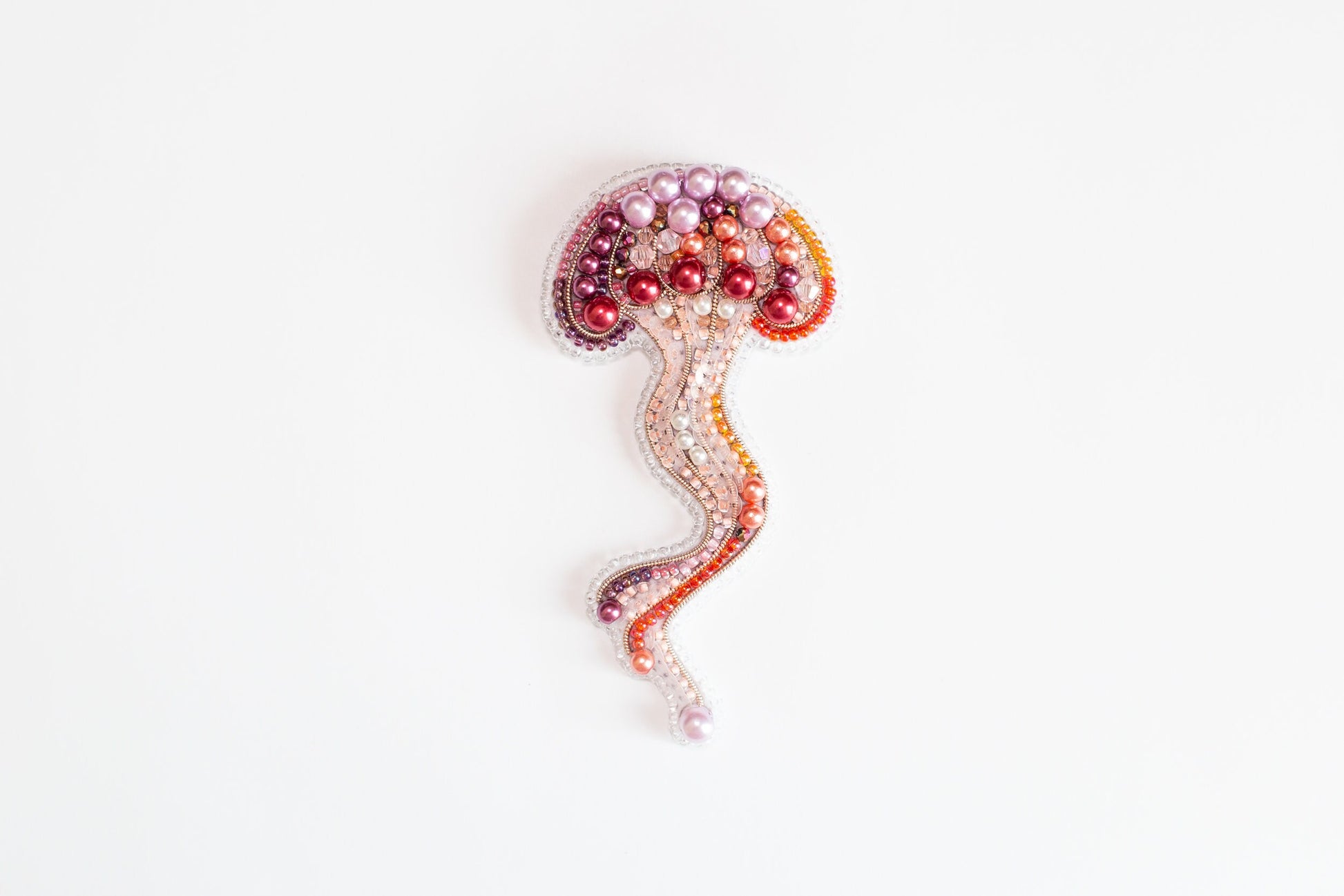 a beaded brooch with a jellyfish on it