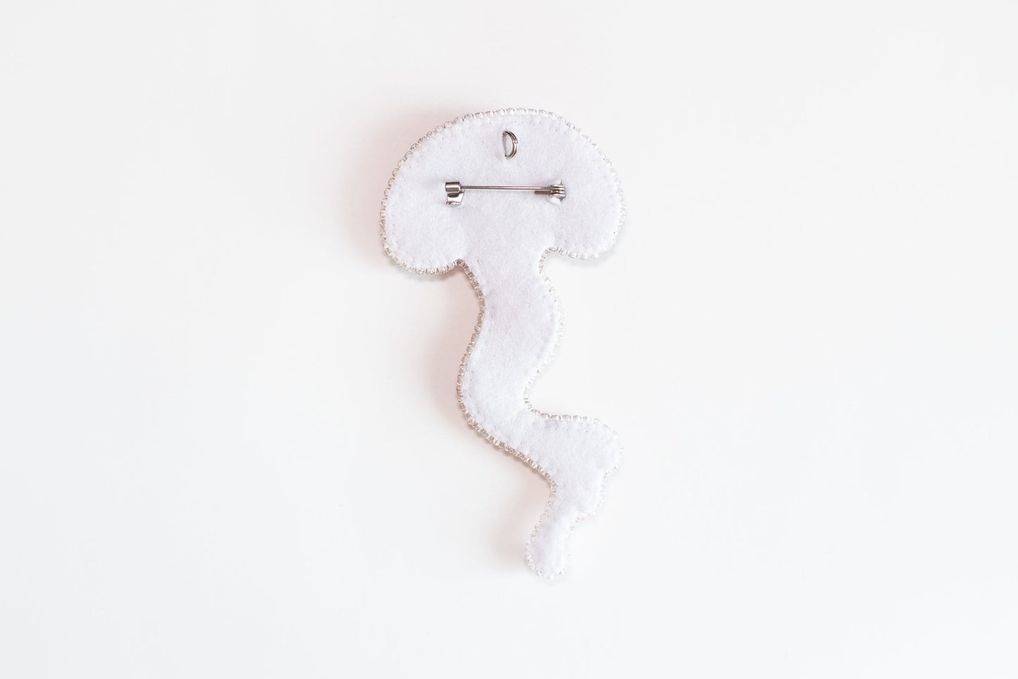 a white piece of cloth with a hook on it