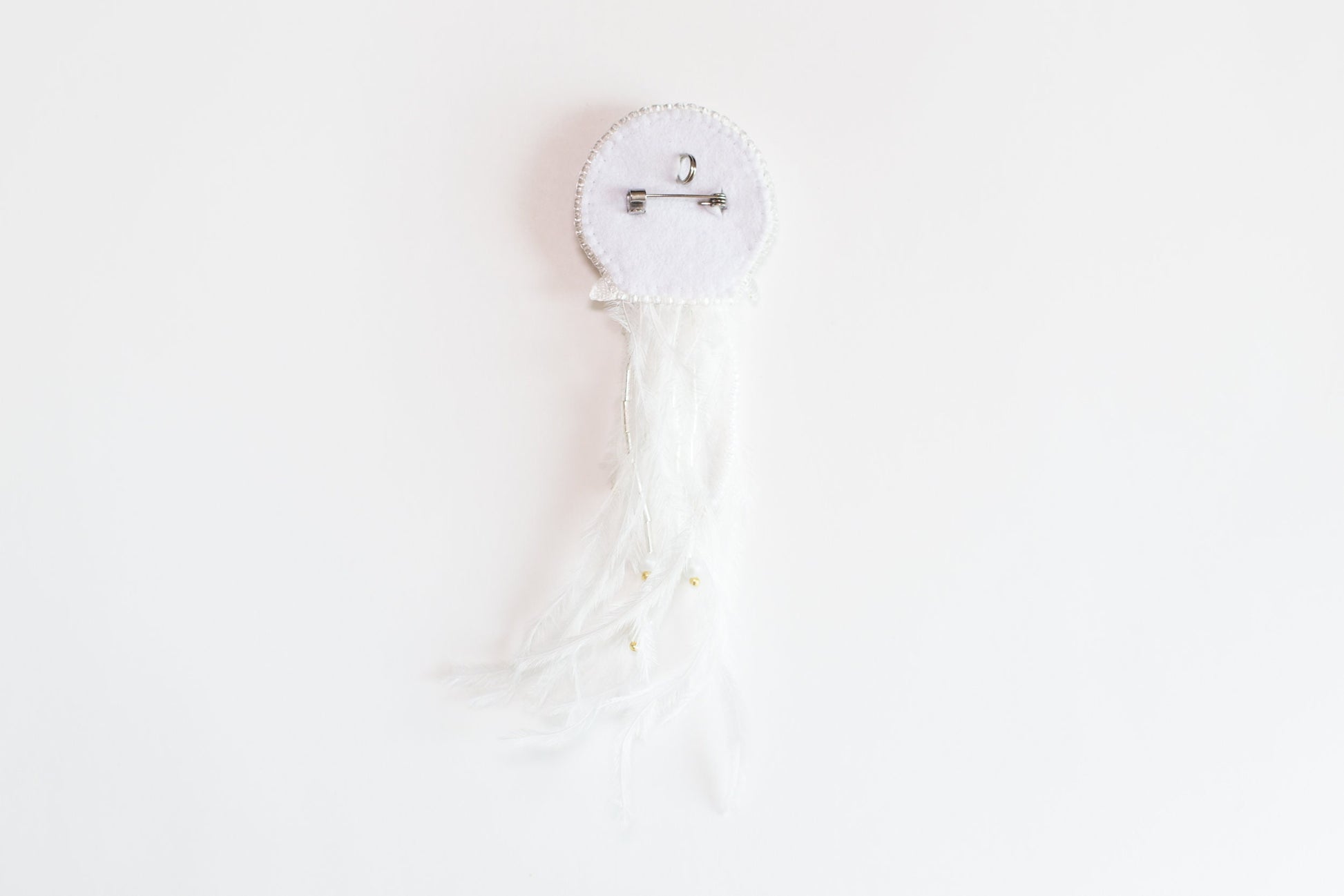 a white piece of cloth with a tassel hanging from it