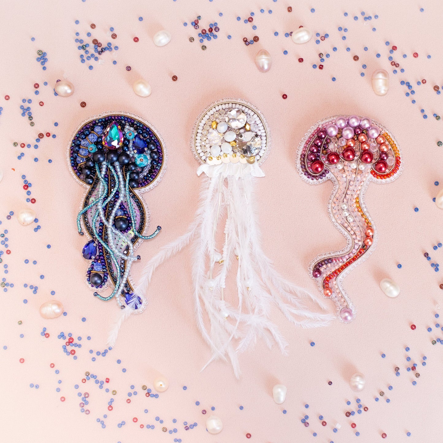 a group of three jellyfish brooches sitting on top of a table