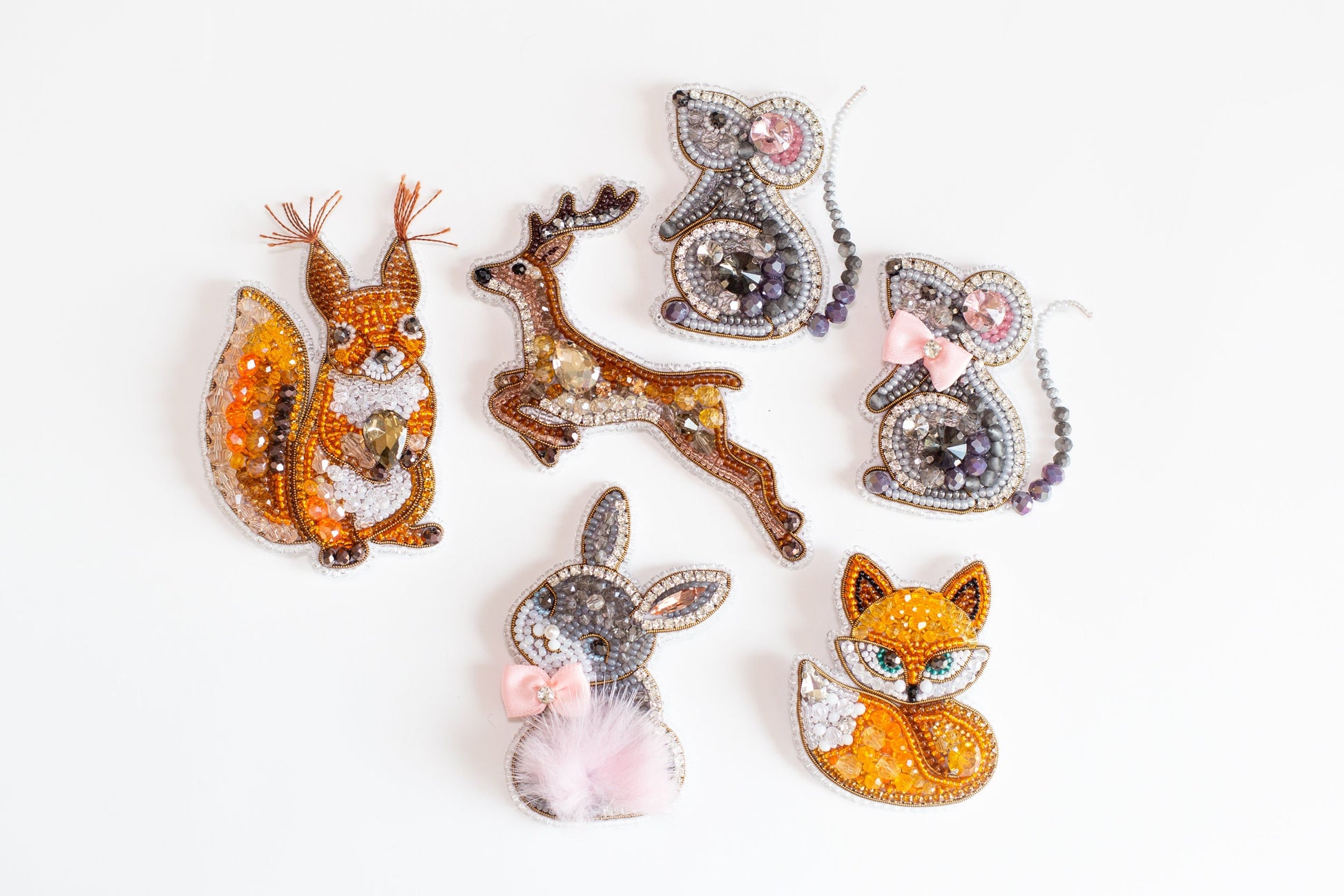 a group of animal brooches sitting on top of a white surface