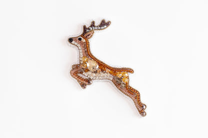 a brooch with a deer design on it