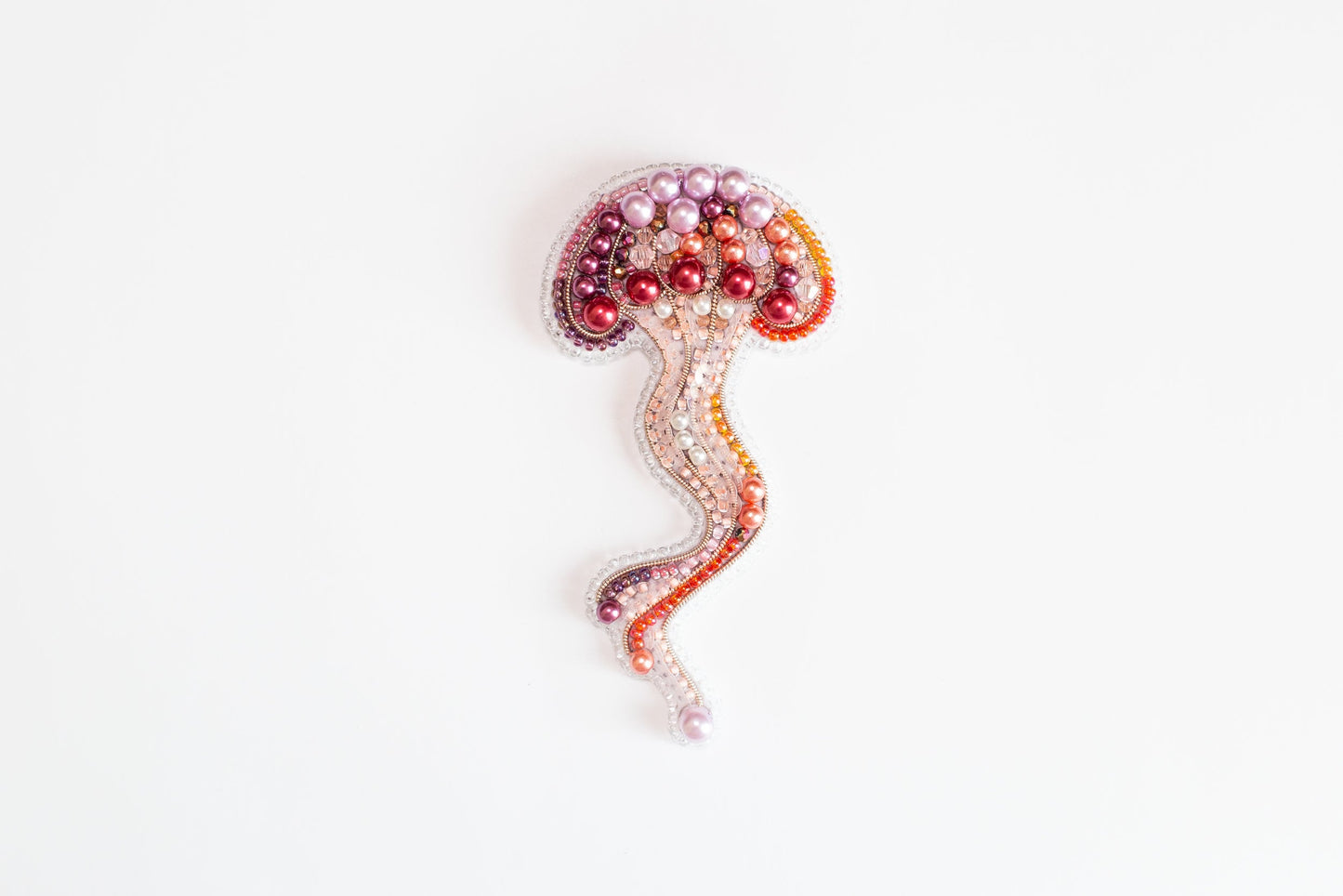 a beaded brooch with a jellyfish on it