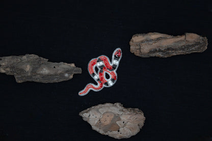 a red and white snake on a black background