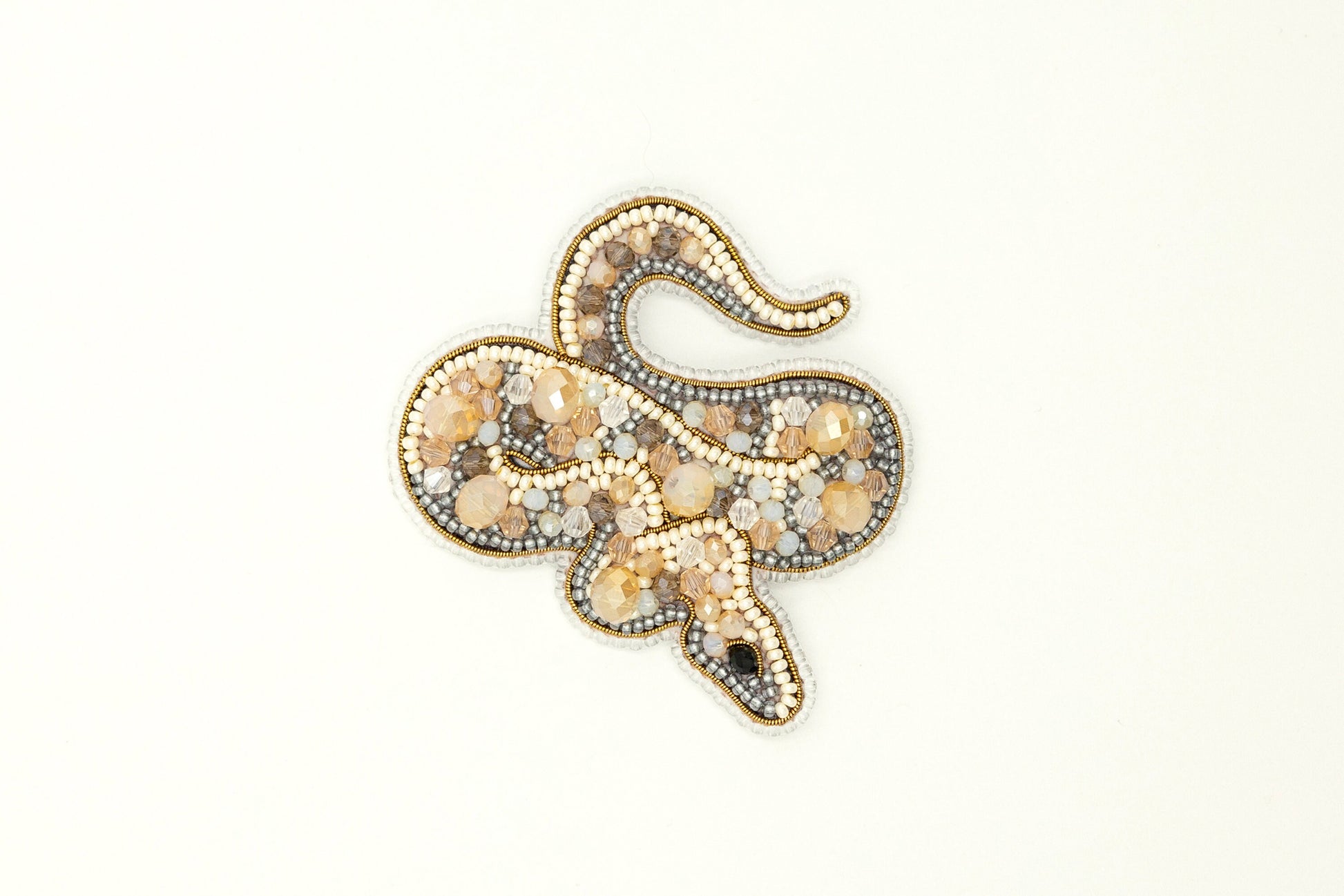 a brooch with a snake design on it