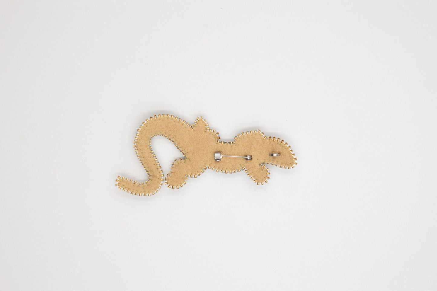 a wooden cutout of a lizard on a white background