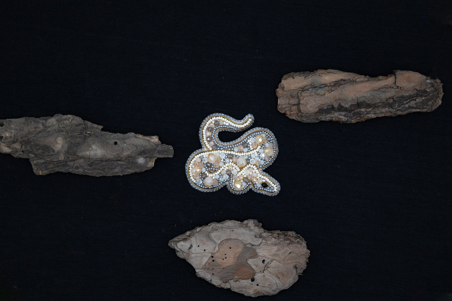 a brooch sitting on top of some rocks